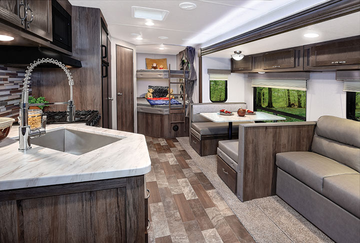 Galley, living space and double bunks inside East to West Silver Lake 27K2D travel trailer