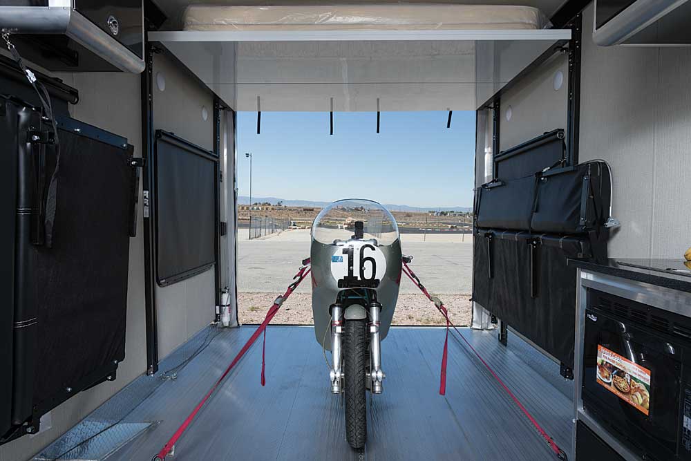 A Ducati 750 Imola motorcycle is well-secured in the garage of the ATC 8528-FB Toy Hauler using the ATC’s adjustable tie-down tracks and 5,000-pound tie-down rings.