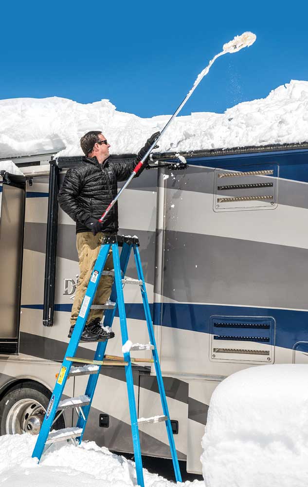 A brush on a telescoping handle and a lightweight ladder help make keeping the roof clear more manageable.