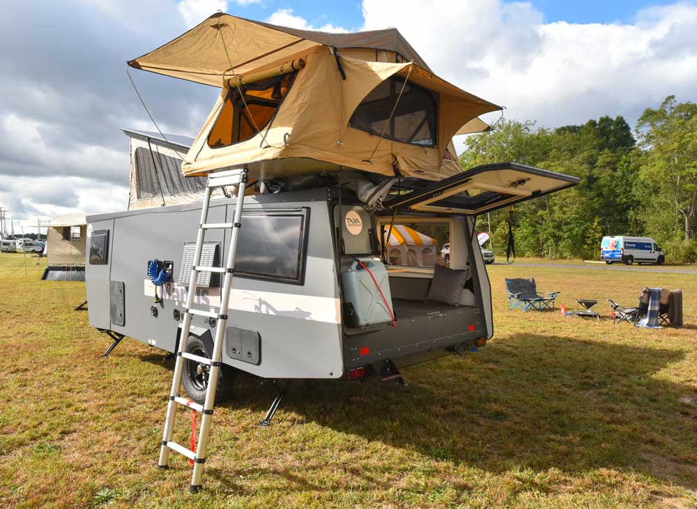 Taxa Outdoors Mantis adventure travel trailer, fully deployed with rooftop tent and interior visible
