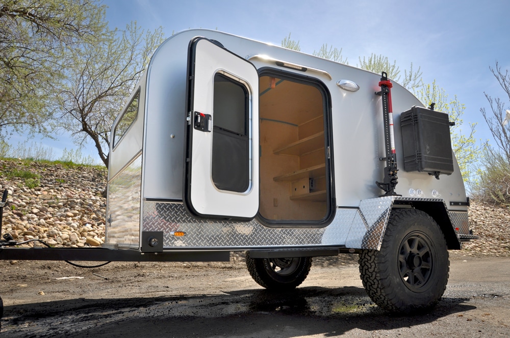 Small white camper with door open