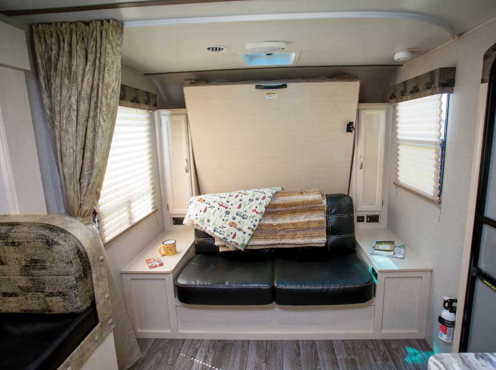 With the bed in its upright position, a sofa adds to the seating options.