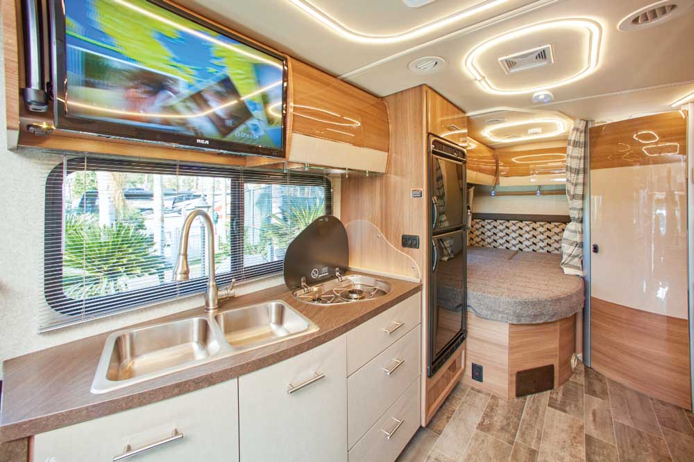 European-style cabinetry adds to the modern look inside the View. Galley is surprisingly roomy and surrounded by generous drawers and cabinets. Bed is tucked in between the passenger-side wall and corner bathroom.