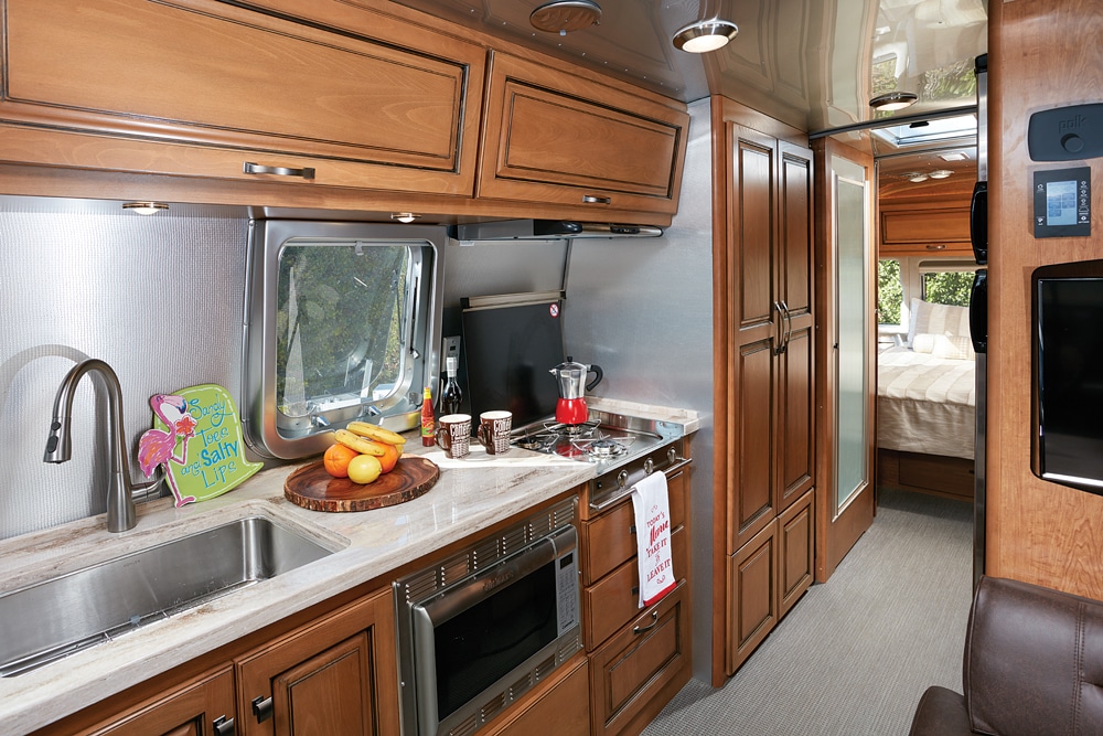 The Airstream Classic 30 has a cheerful feel with its well-lit galley, light Sandalwood Corian countertop with uncrowded work space, warm-toned Cognac Maple cabinetry and overall spacious living area that made us feel right at home.