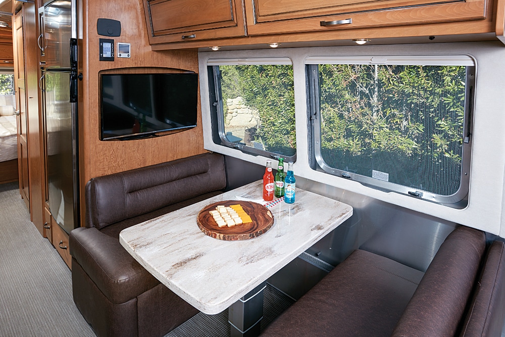 Dual tempered, tinted windows over the dinette allow occupants to enjoy the view while dining. The dinette converts into a bed via the telescoping table with the press of a button.