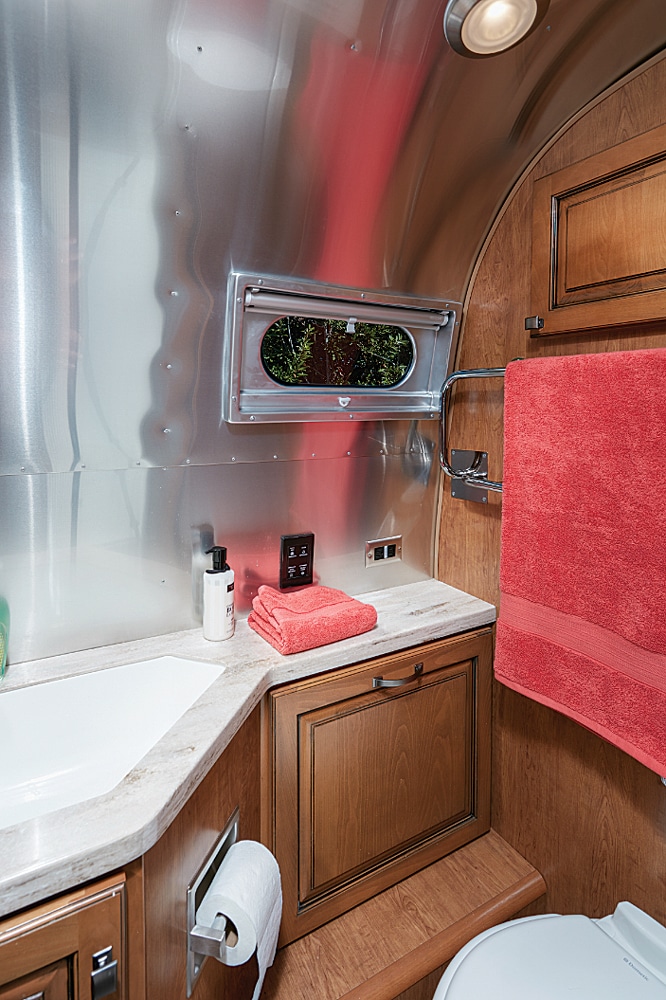 bathroom view of sink, toilet, and heated towel bar in airstream classic