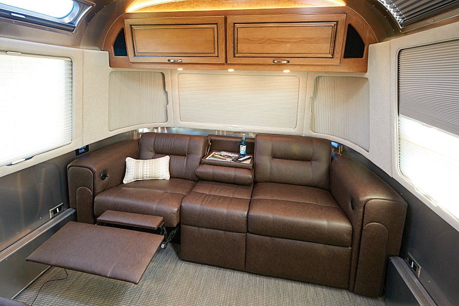 Powered footrests add more comfort to the plush Ultraleather sofa in Airstream