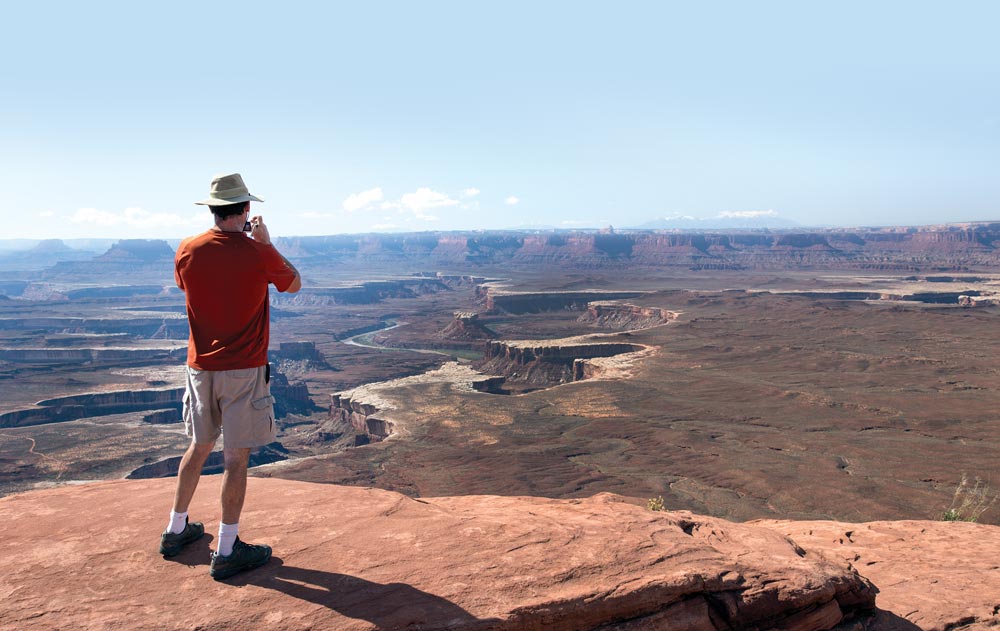 Man taking pictures at the Green River Overlook