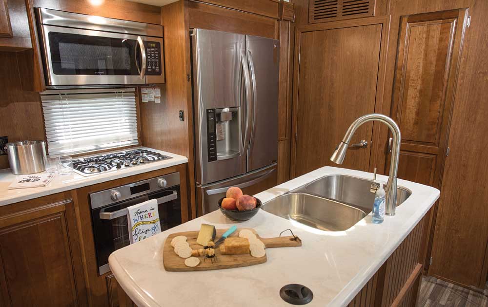 It was a joy to cook in the Cardinal’s well-equipped kitchen with the Furrion RV Chef Collection three-burner cooktop and oven. The island, with pendant lights, provides a well-lit central area for efficient food prep. 
