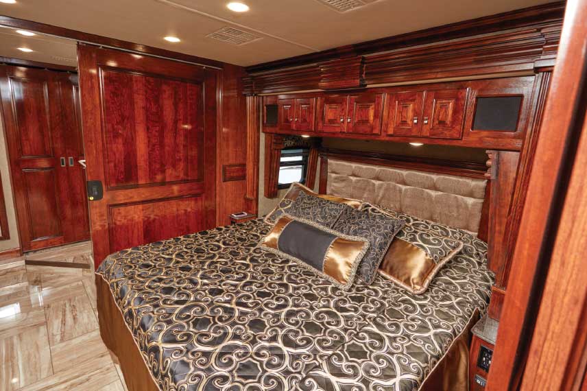 King-size Dream Easy Series mattress is pure relaxation, there is abundant cabinetry for storage, and sliding doors close the bedroom off from the living area and master bathroom.
