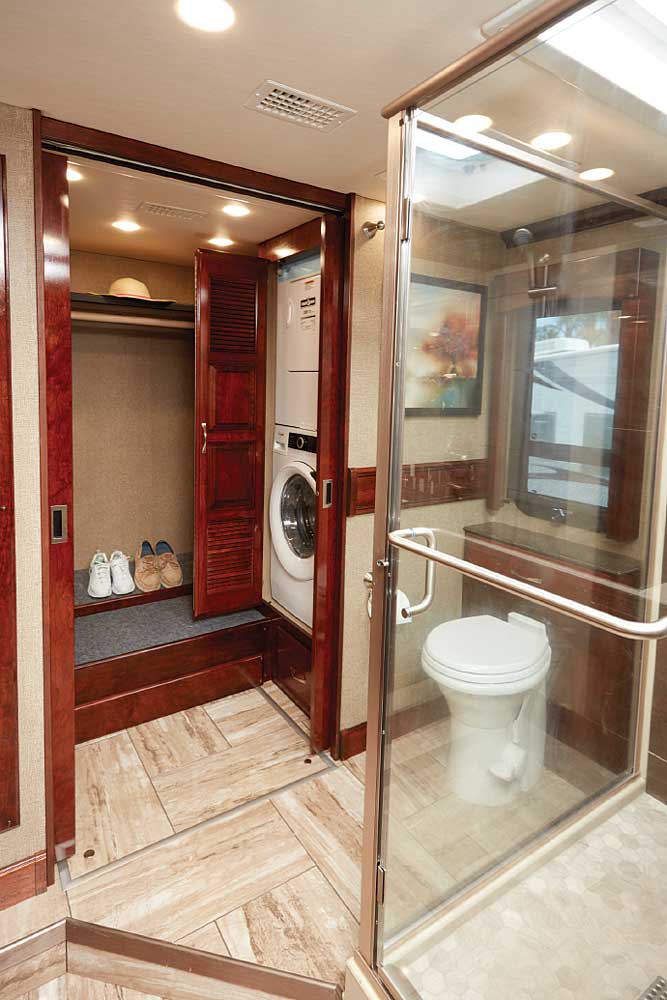 Spacious master bath carries the open feel with a glass-enclosed shower and excellent lighting. A step up leads to toilet and large closet housing washer and dryer.