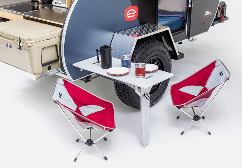 Side table and two folding chairs on Escapod Topo trailer.