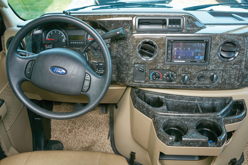 The carpeted cockpit is set up for efficiency and comfort and features an attractive burlwood-finish dashboard. There are good nooks and crannies for stowing small and large items.