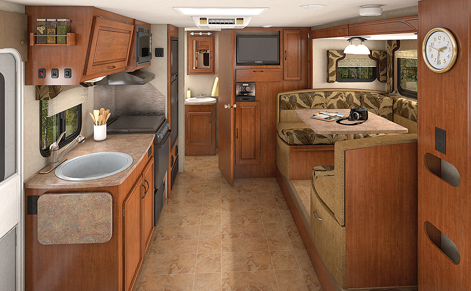 Take a look at how precisely the cabinetry fits, particularly at the ceiling; trim pieces aren't needed to hide the gaps on a Lance trailer. The entertainment center can be viewed easily from two sides of the dinette and the 60 x 80-inch queen-size bed.