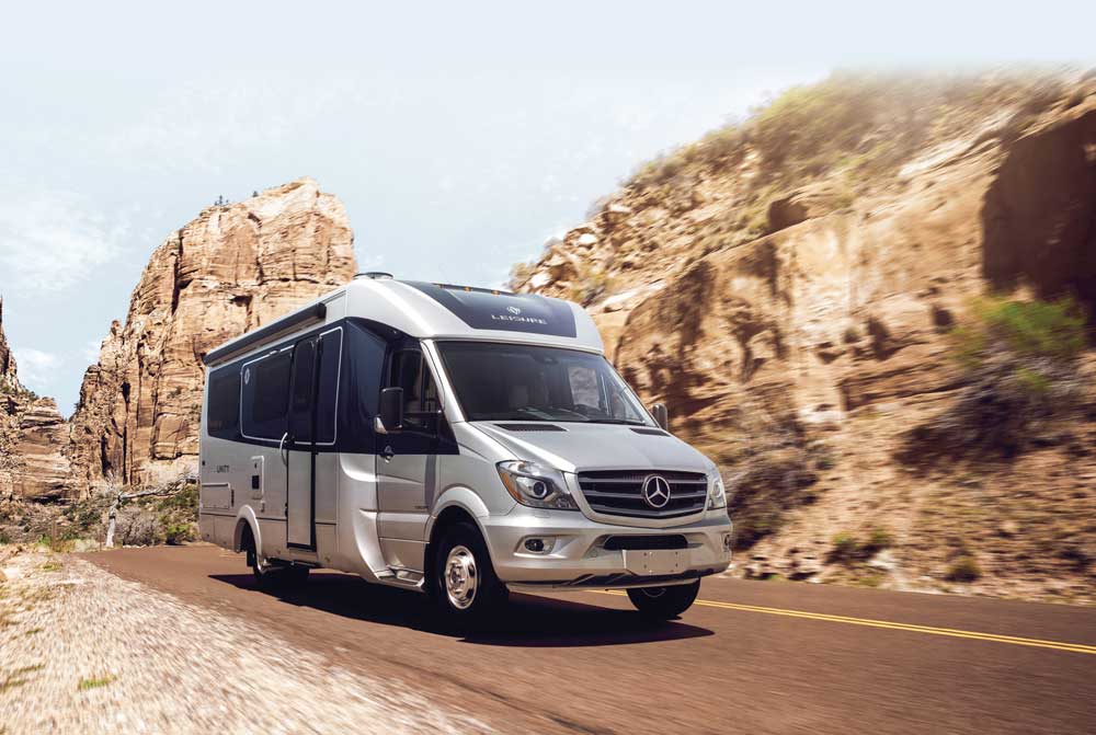 Leisure Travel Vans Unity Island Bed exterior driving on desert road