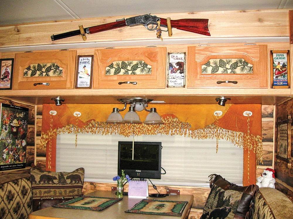 Every corner of this Concord motorhome is outfitted as a mountain getaway. Beneath the nonfiring Winchester rifle, bears adorn the walls (and pillows) of the dinette area.