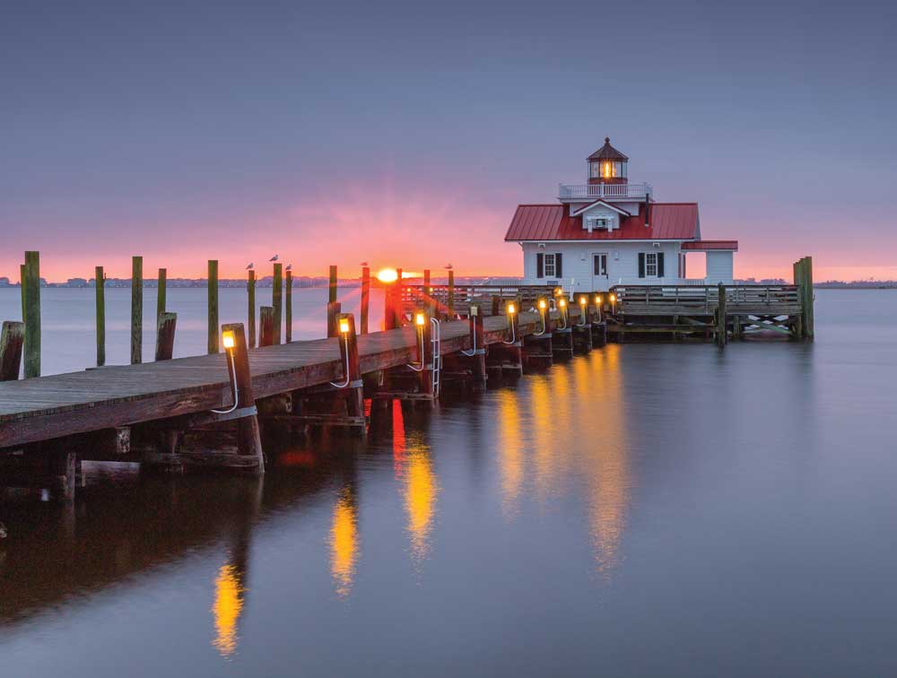  Manteo’s Roanoke Marshes Light is a replica of the cottage-style screw-pile lighthouse that stood at the entrance to Croatan Sound. The lighthouse contains exhibits highlighting the area’s maritime history and guides boats into Shallowbag Bay.