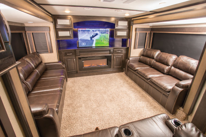 A trio of brown leather couches, one with theater seating for two  