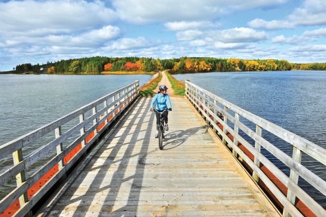 woman riding bike on bridge