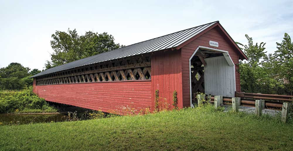The lattice-truss Paper Mill Bridge, built in 1889, spans the Walloomsac River northwest of Bennington.