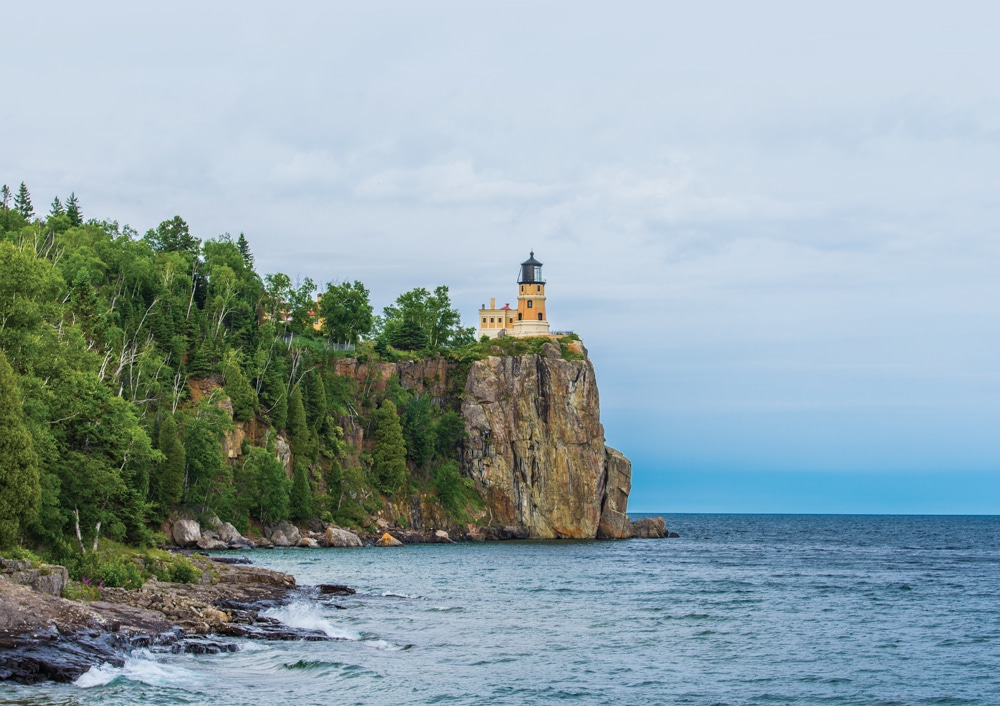 Split Rock Lighthouse , a picturesque landmark, towers above Lake Superior from its cliff-top perch.