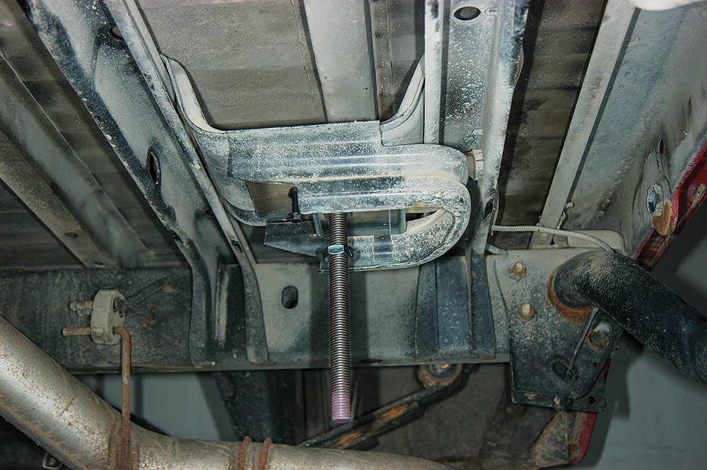 (8) The truck-mounting plate is bolted to the old spare-tire winch location using supplied fasteners.