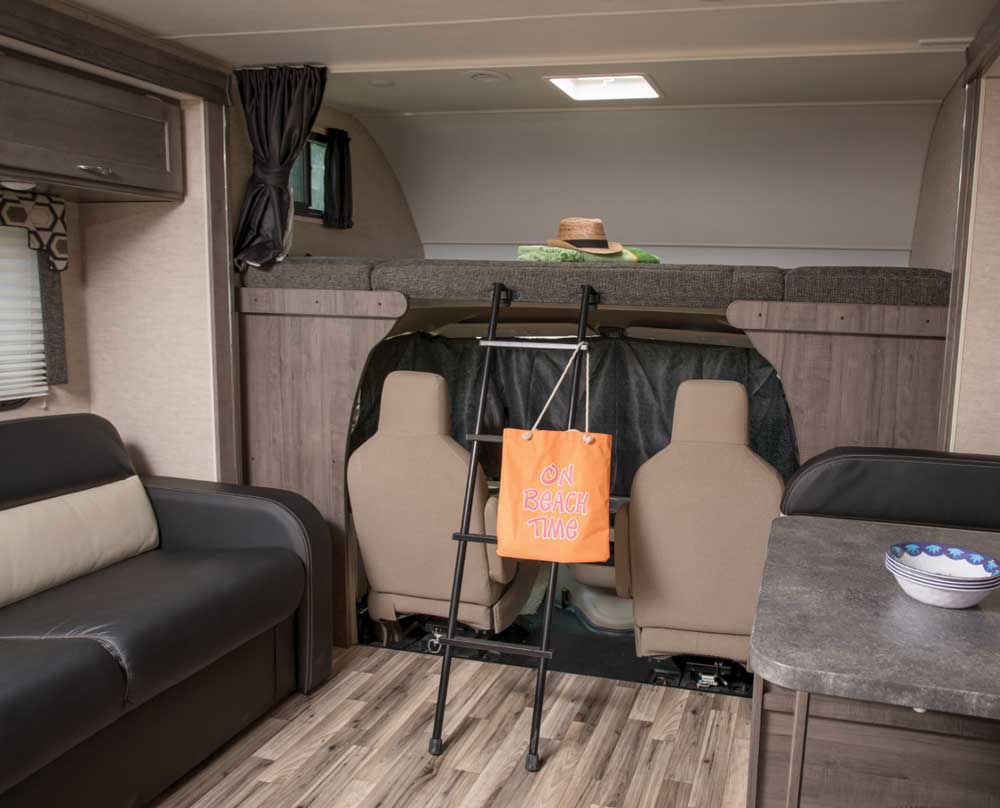 Attaching the privacy curtain in the cab was quick work, and the captain’s chairs swivel around for additional seating. The cabover bed is almost the width of a queen-size mattress. 