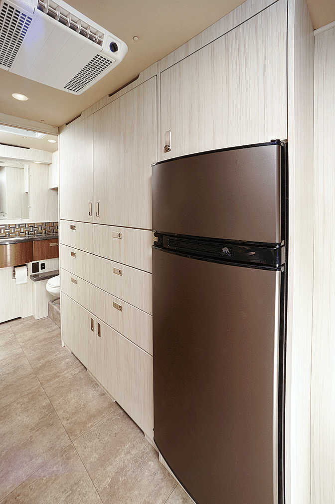 An impressive wall of drawers, cabinets and a refrigerator/freezer stands across from the galley.
