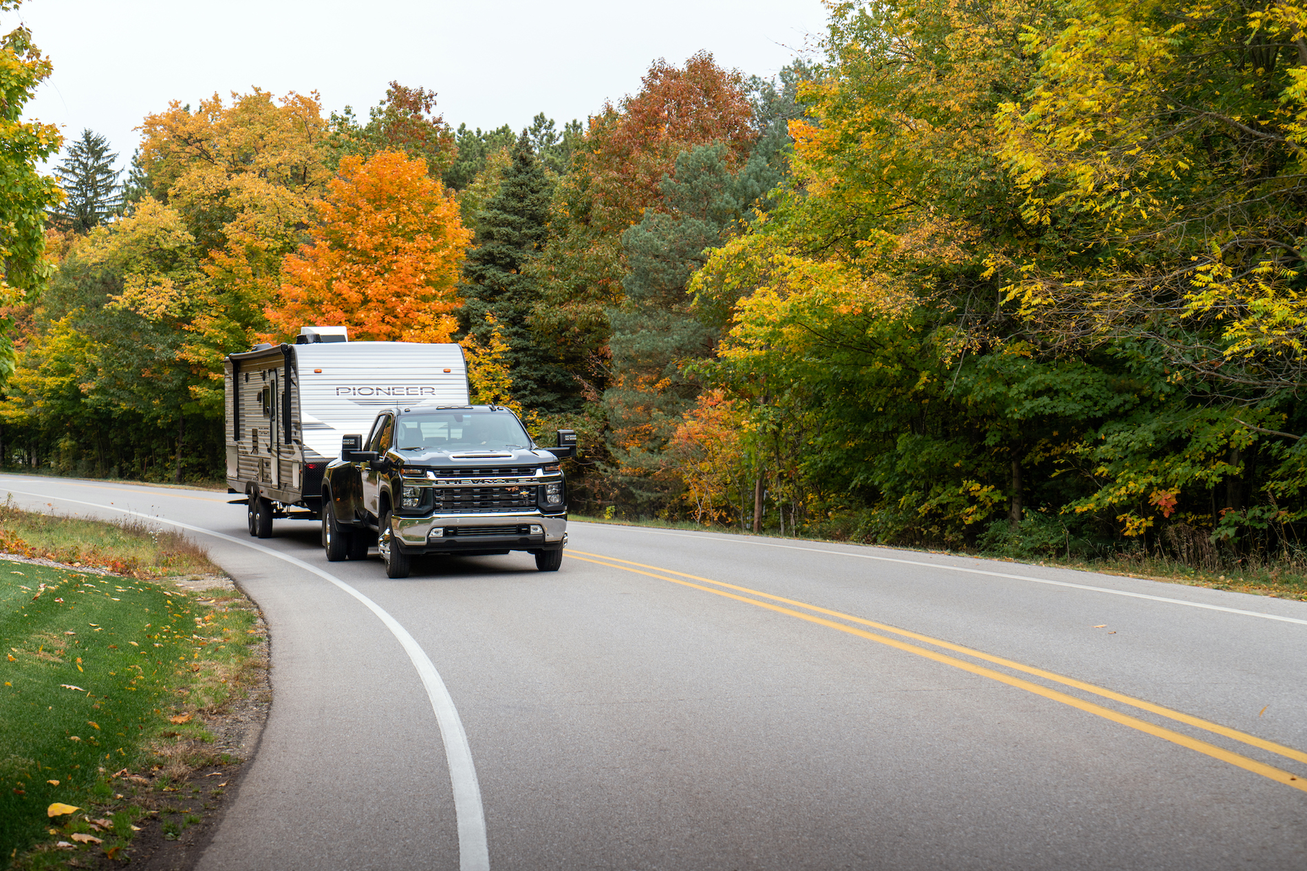 truck pulling a heartland pioneer travel trailer