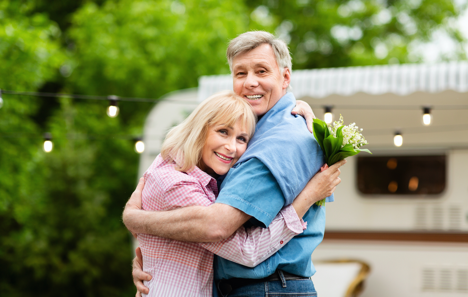 Loving Couple with Camper and Flowers