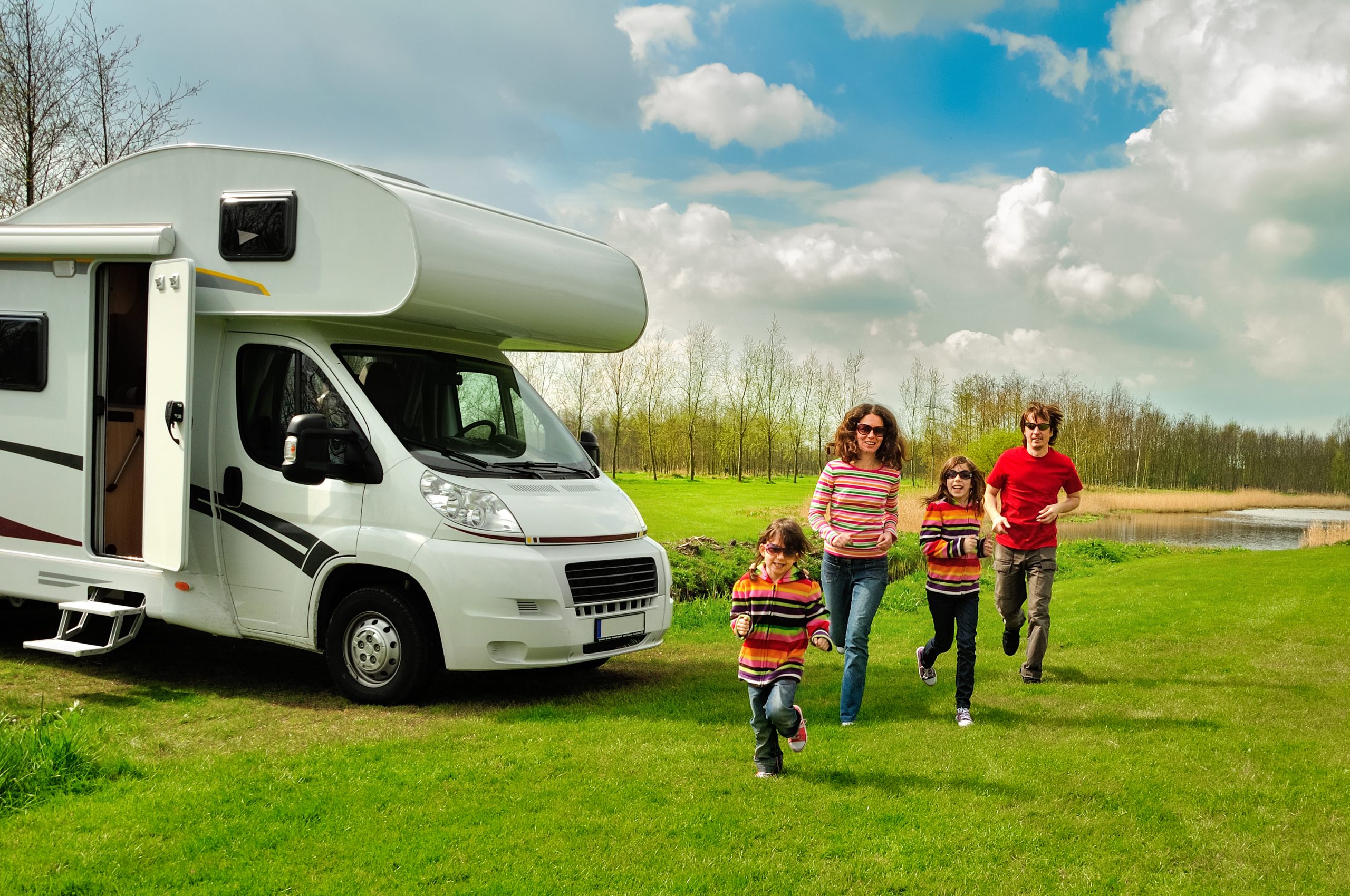 Family vacation, RV travel with kids, happy parents with children have fun on holiday trip in motorhome, camper exterior