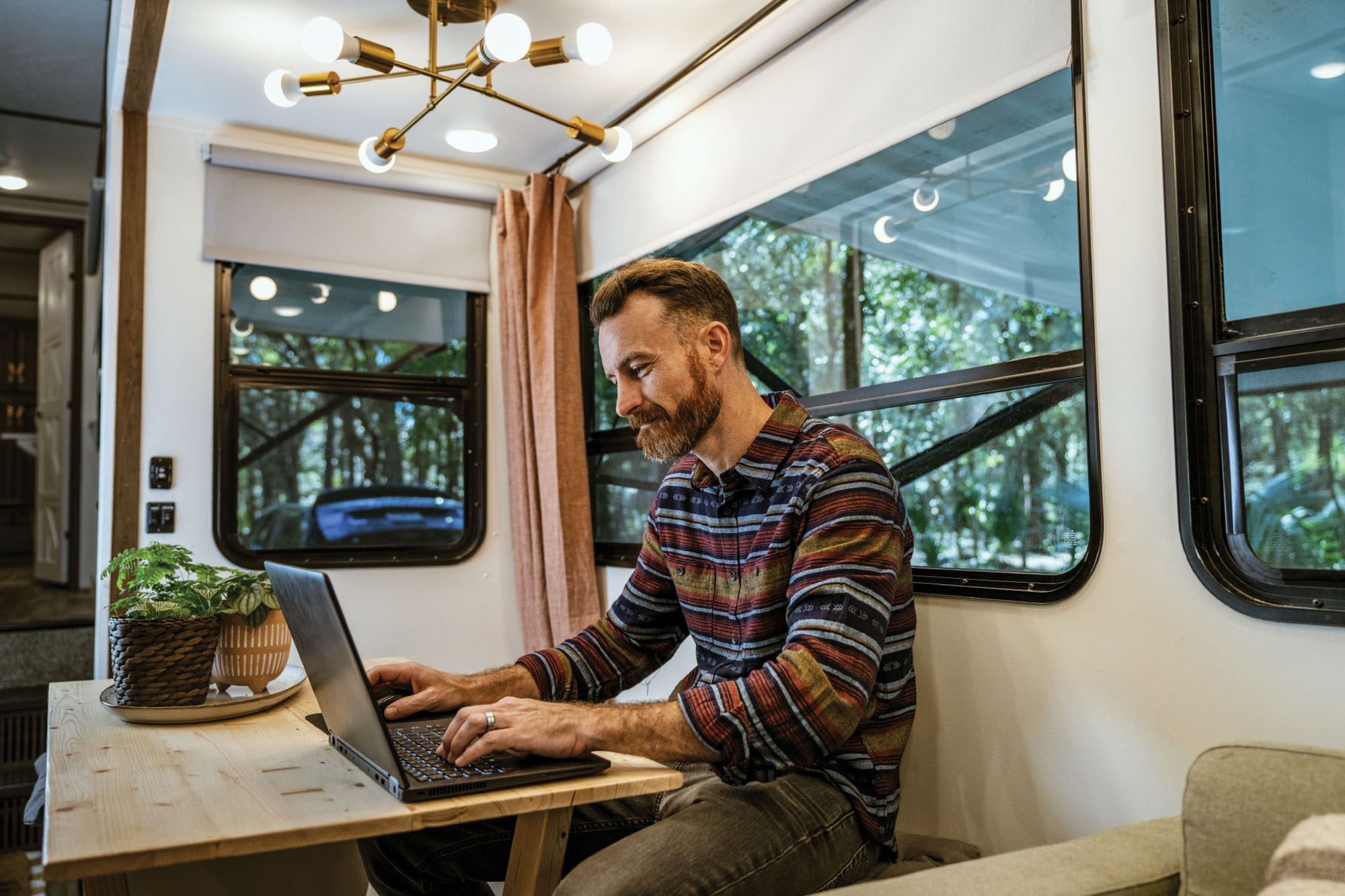 Man Working on Laptop in RV