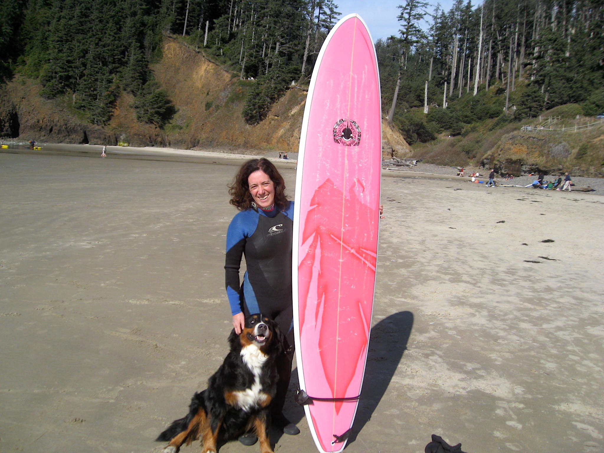 Ariel Frager with surfboard and dog.