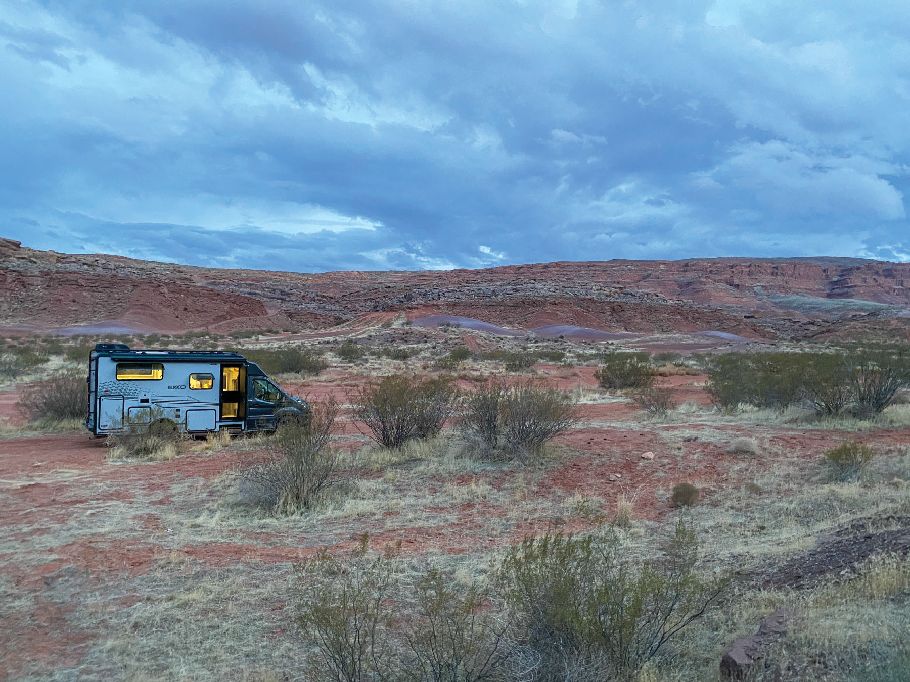 RV in Desert with Interior Lights On