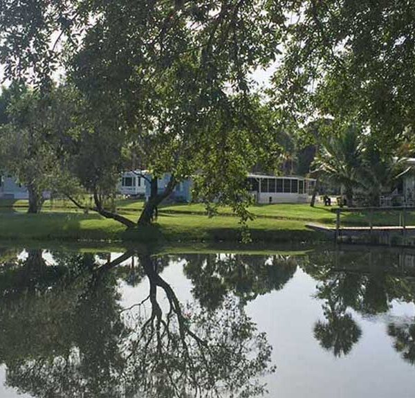 Row of park models overlooking placid pond.