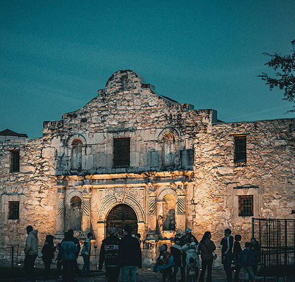 Monument of old mission against darkening sky.