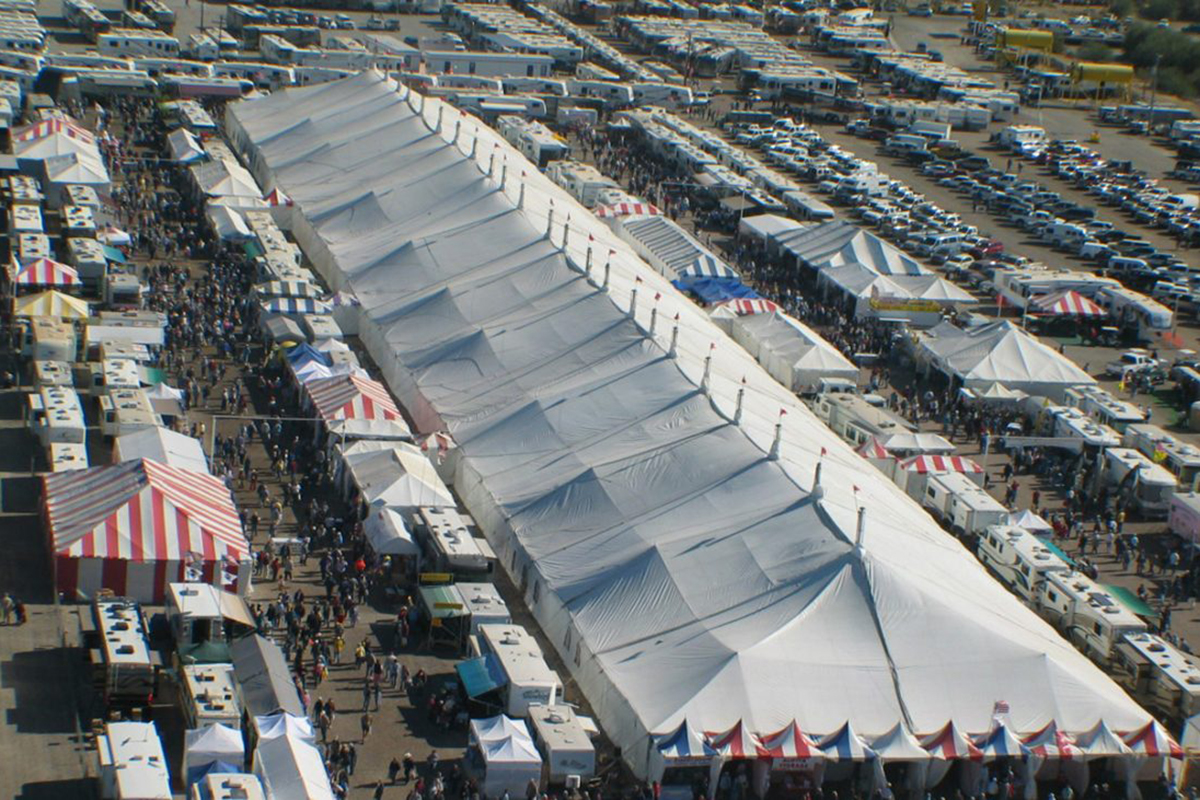 A giant tent flanked by RVs.