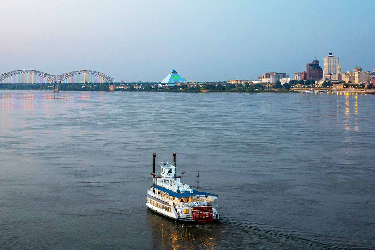 Lone paddleboat on vast river.