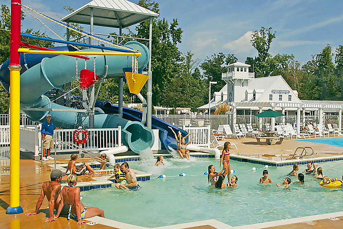 Bathers in a pool with waterslides.