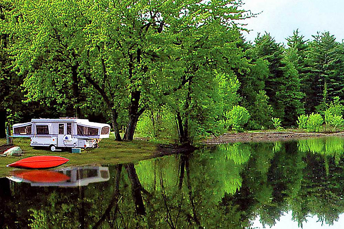Camping trailer close to a lake.