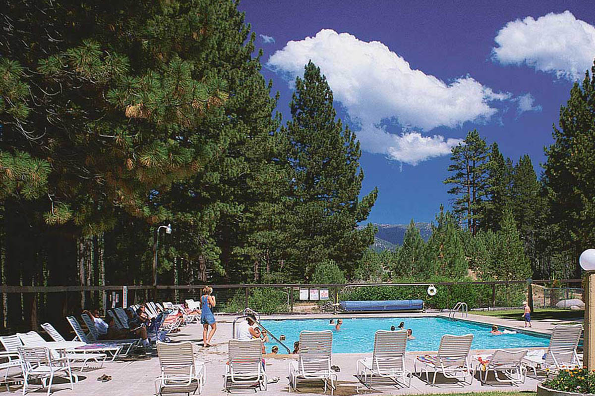 Deck chairs arrayed around a square pool.