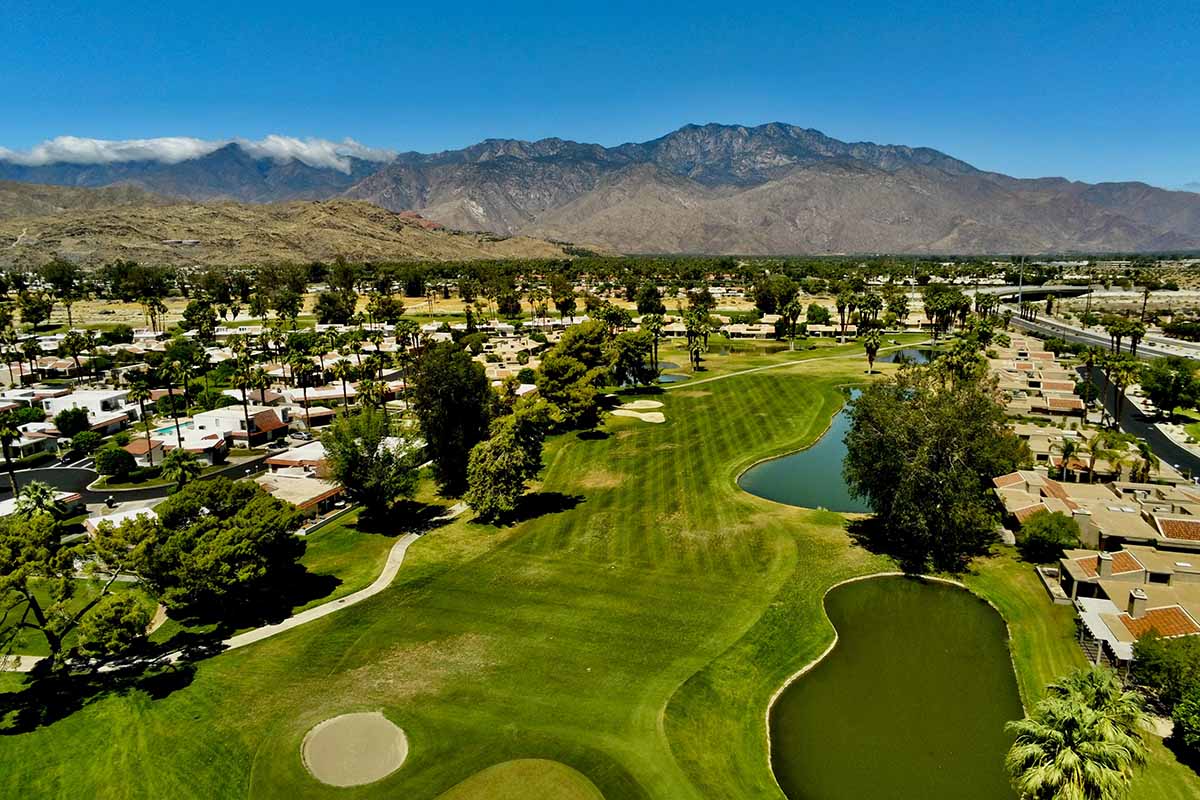 A golf course cuts through the desert.