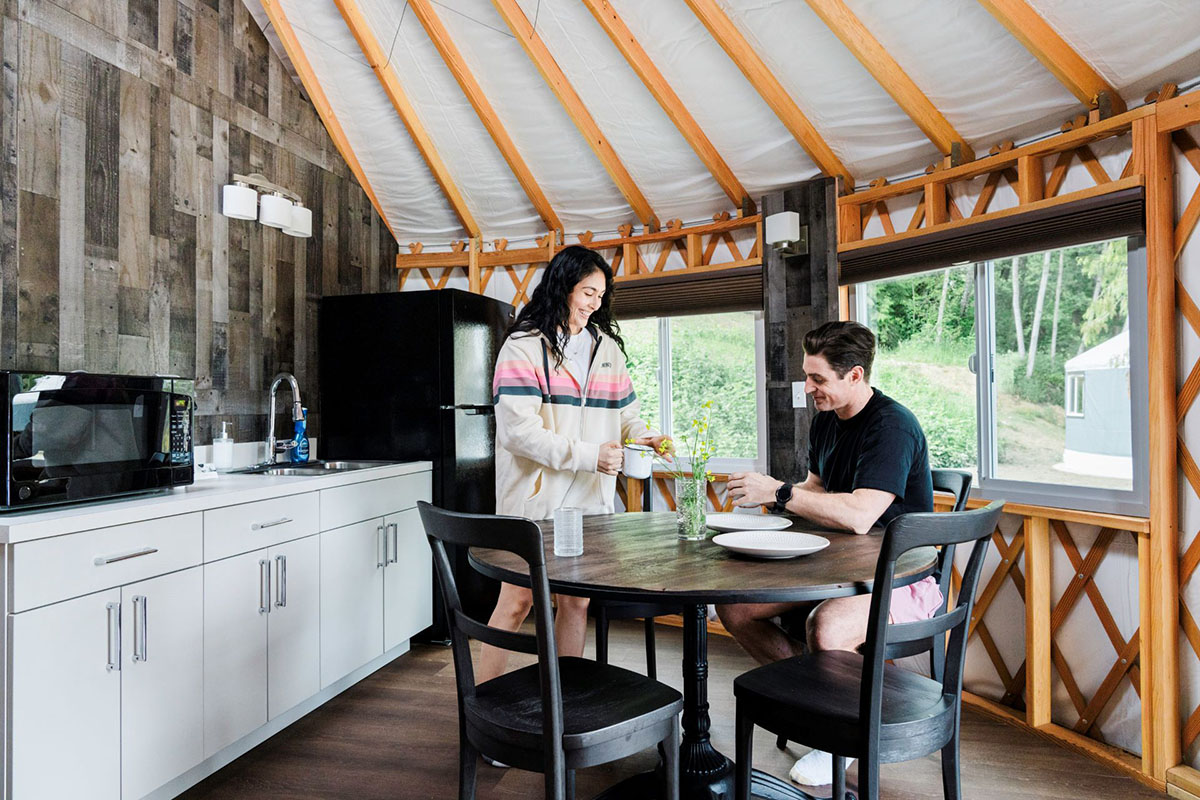 A couple relaxes in a yurt.