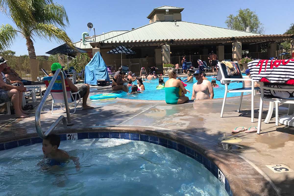 Bathers gathered around swimming pool.