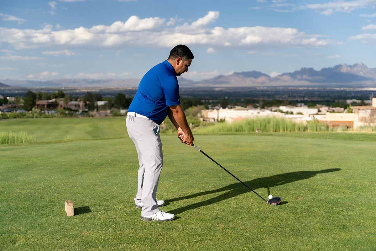 Golfing in a desert setting.