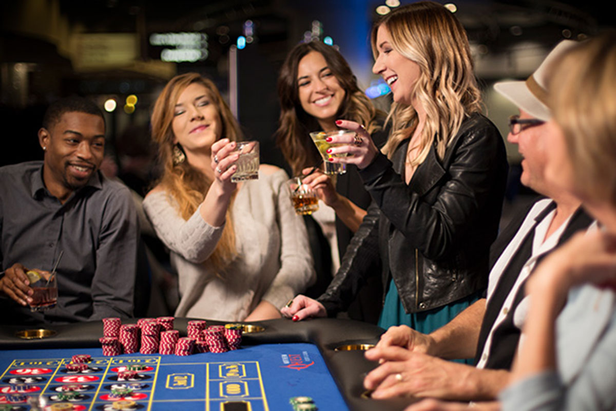 People at a craps table drinking cocktails.