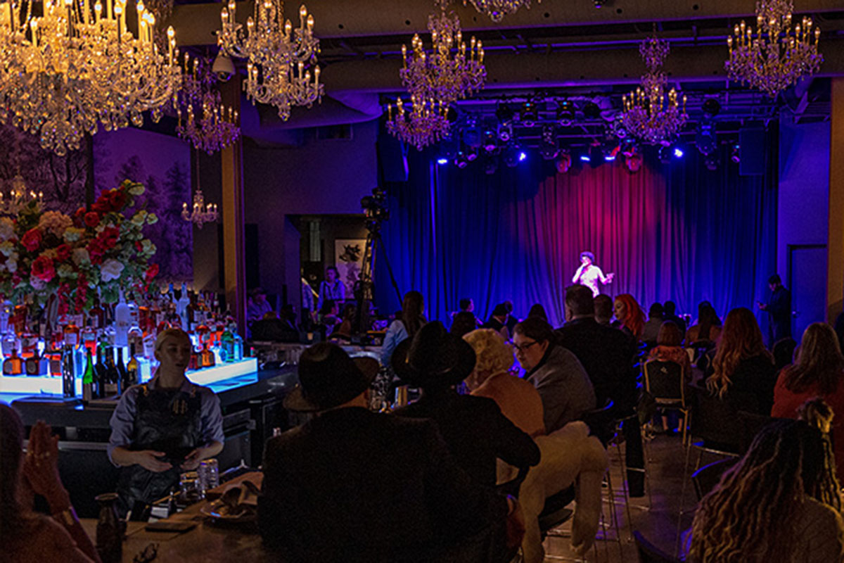 Woman performing on stage in an entertainment venue.