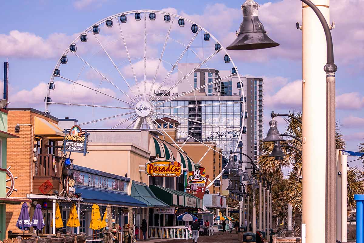 Bustling boardwalk and Ferris wheel.