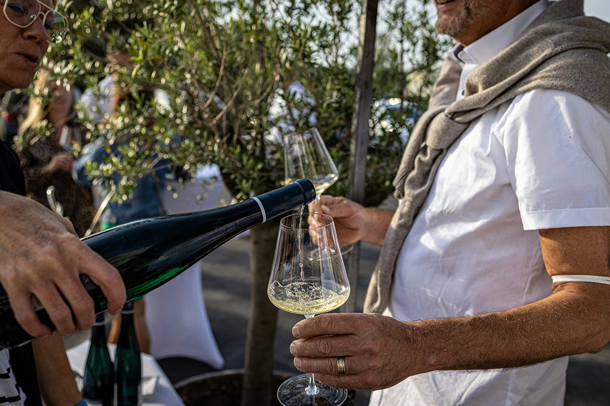 Man drinking white wine like Dionysian titan.