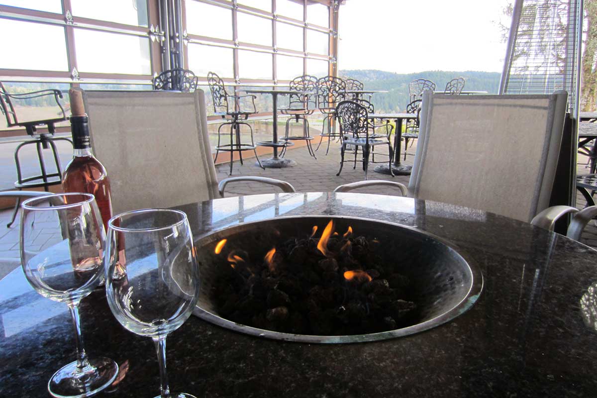 Fire pit with wine glasses nearby.